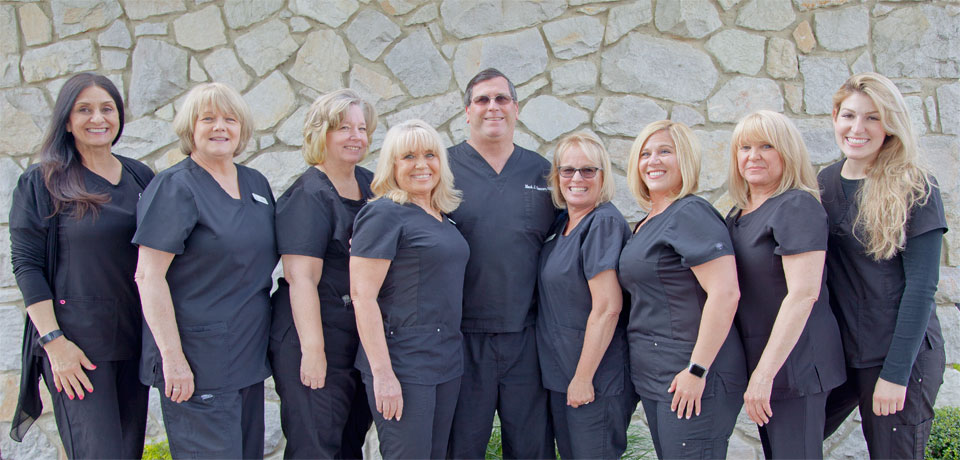 Dr. Mark Danner and staff standing outside of the dental practice office located in Sewell New Jersey